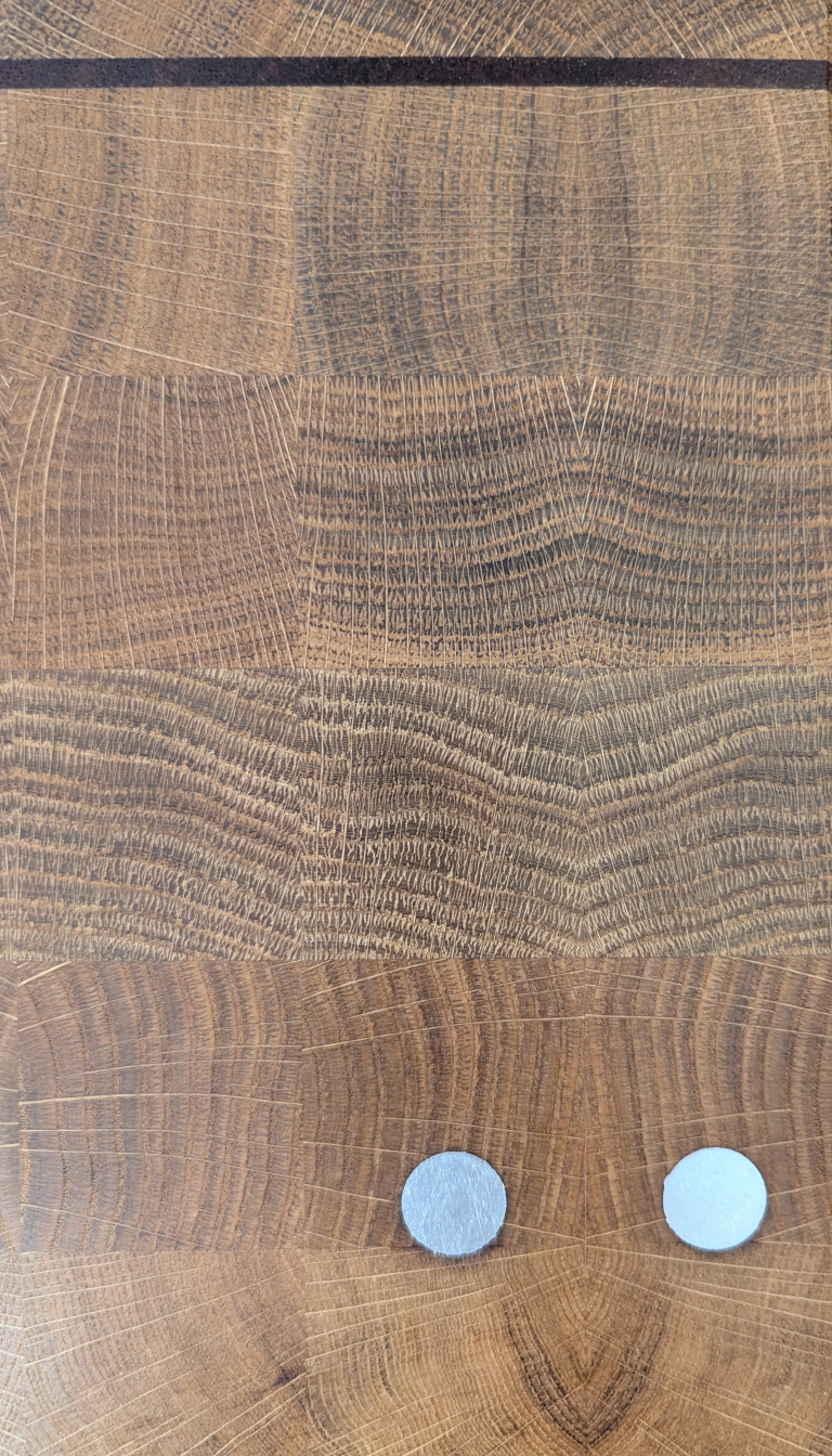 Detailansicht des liveDROPS Stirnholz-Schneidbretts mit Maserung und Zinn Inlays